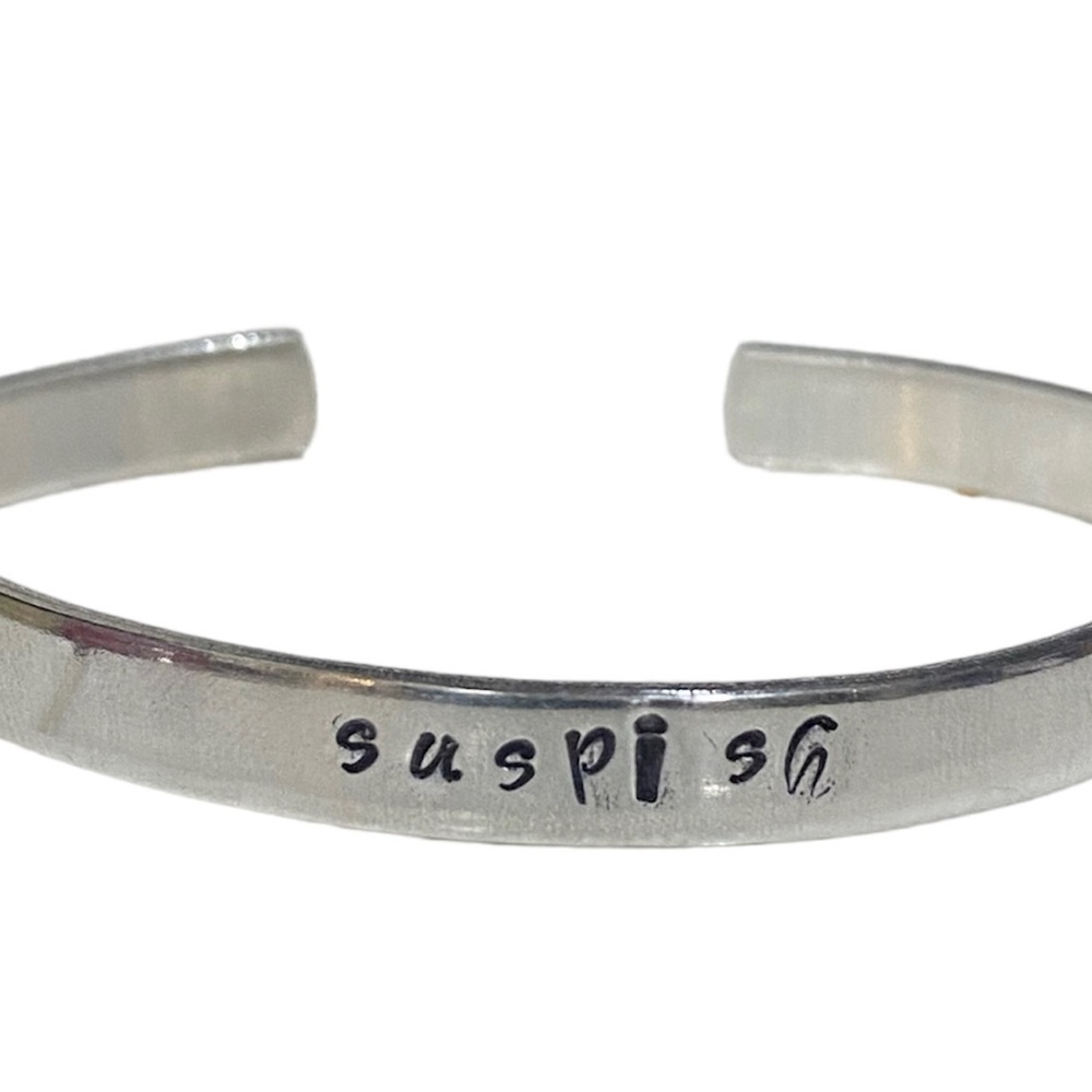 Handcrafted 100% food grade aluminum. Cuff bracelet with “Suspish”